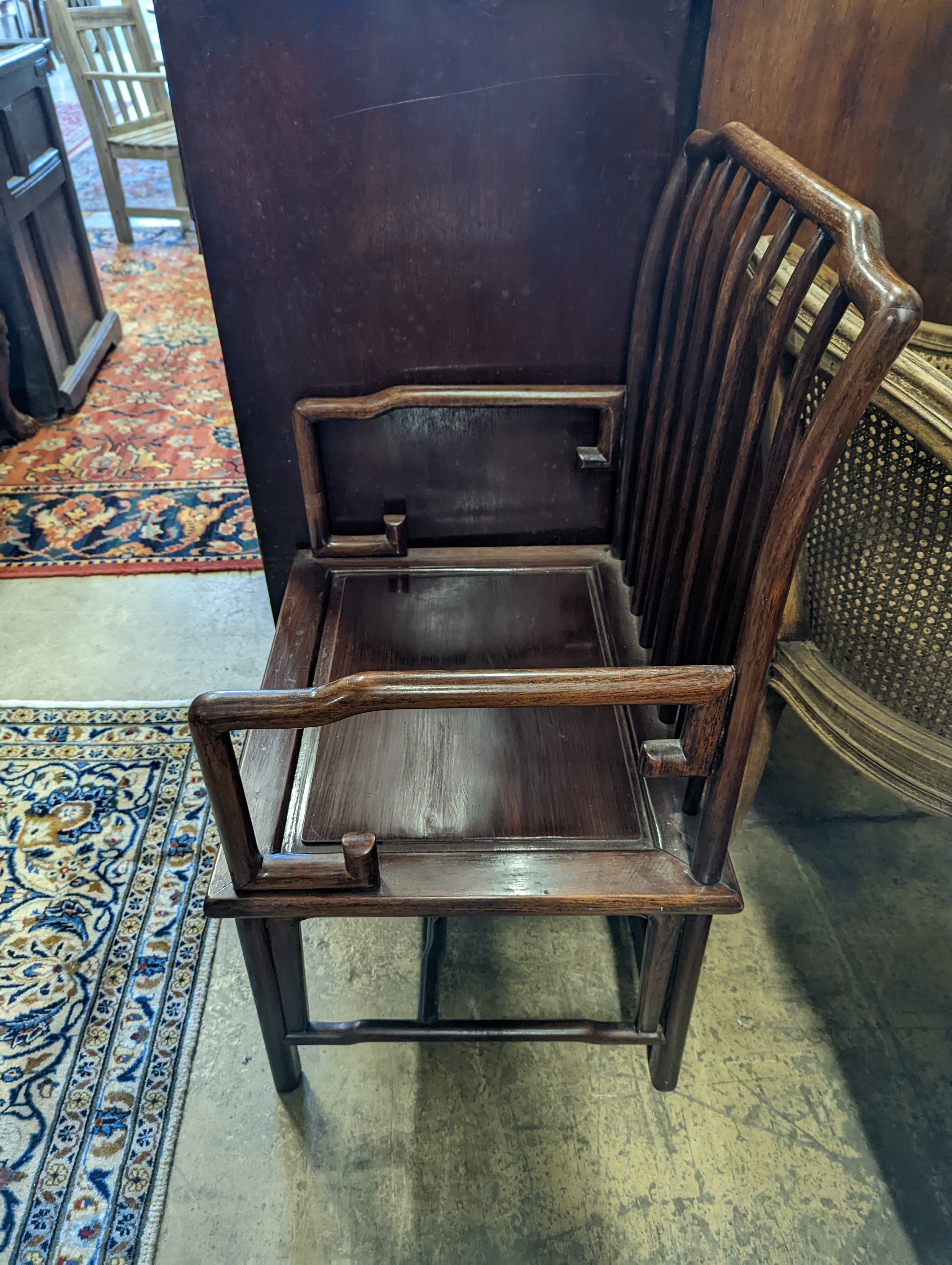 A pair of mid 20th century Chinese Hongmu elbow chairs with cushion seats, width 58cm, depth 49cm, height 92cm